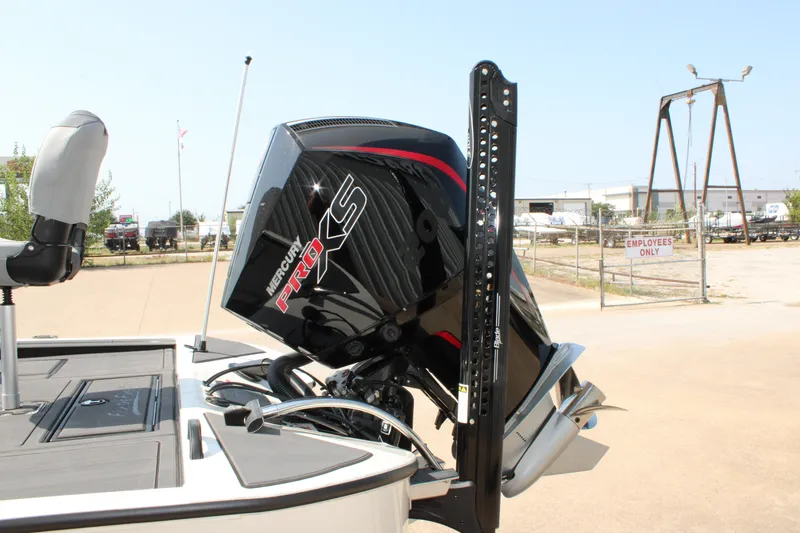 Slide: The Image of 2027 Tracker Savage 215 boat with Mercury Pro XS engine in a parking area. - 15