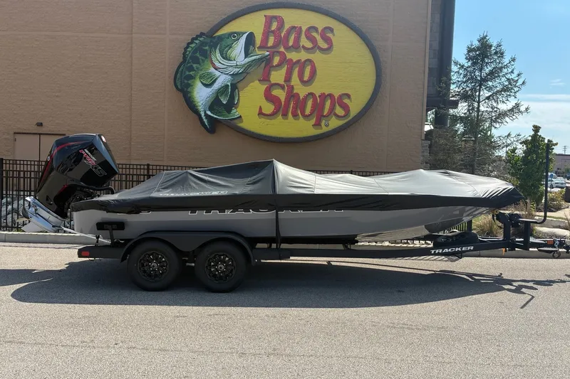 Slide: The Image of 2027 Tracker Savage 215 boat covered, parked outside Bass Pro Shops. - 16