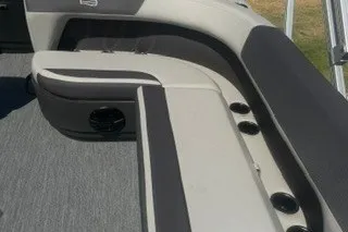 Slide: The Image of 2027 Sun Tracker Bass Buggy 18 DLX boat interior with cushioned seating and cup holders. - 13