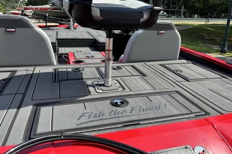 Slide: The Image of 2027 Tracker Savage 215 boat deck with seating, featuring "Fish the Finest" slogan. - 15