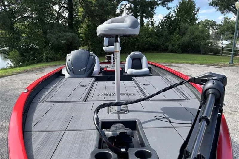 Slide: The Image of 2027 Tracker Savage 215 boat with seating and fishing deck, parked outdoors. - 14