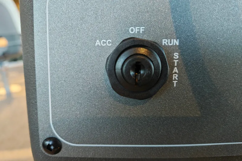 Slide: The Image of Close-up of ignition switch on 2027 Sun Tracker Bass Buggy 16 XL Select boat. - 22