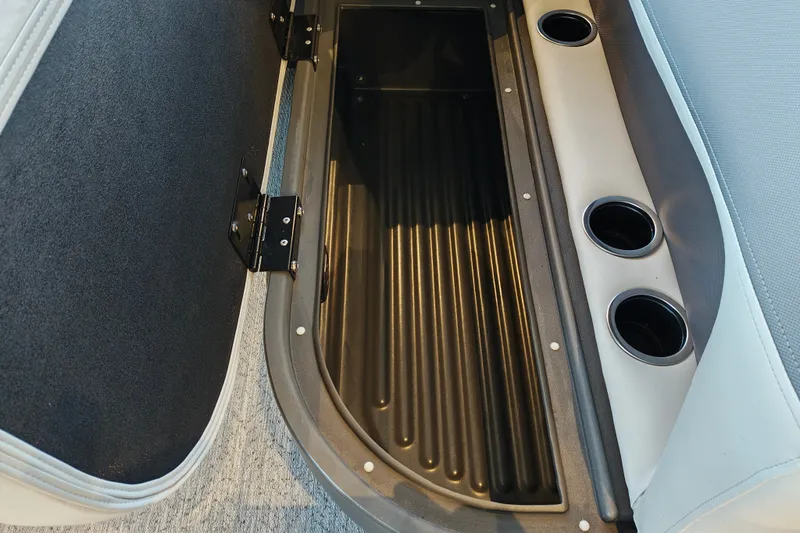 Slide: The Image of 2027 Sun Tracker Bass Buggy 16 XL Select storage compartment with cup holders. - 32