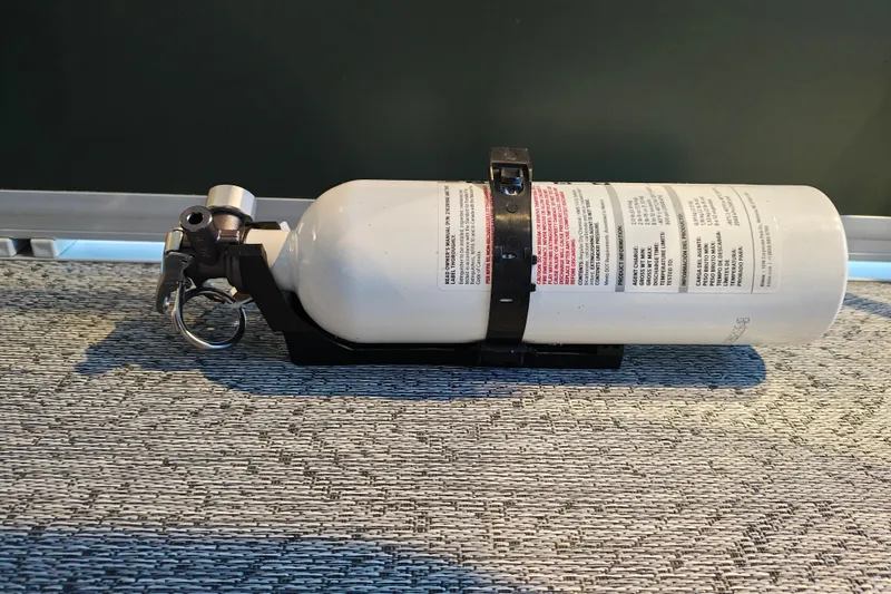 Slide: The Image of Fire extinguisher mounted on a Sun Tracker Bass Buggy 16 XL Select, 2027 model. - 25