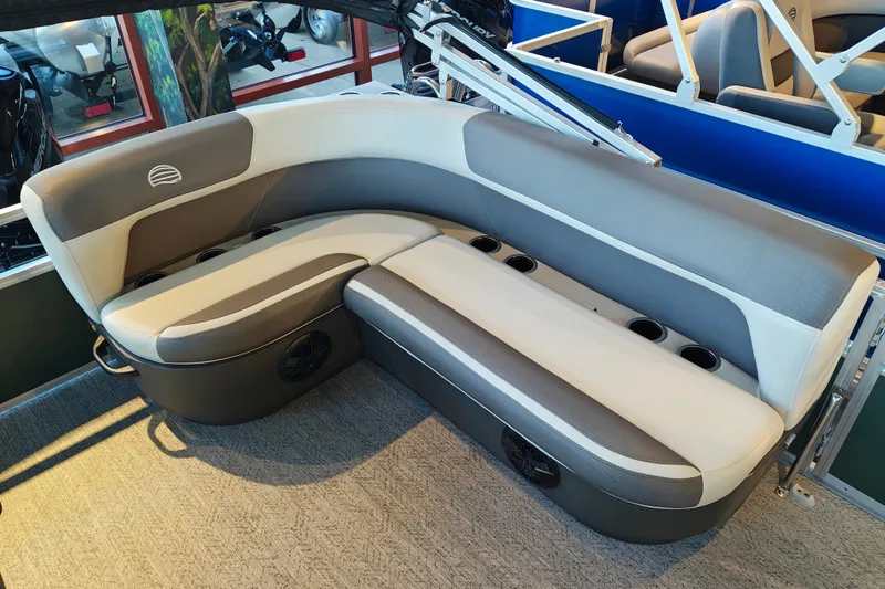 Slide: The Image of 2027 Sun Tracker Bass Buggy 16 XL Select boat seating, featuring gray and white upholstery with cup holders. - 28