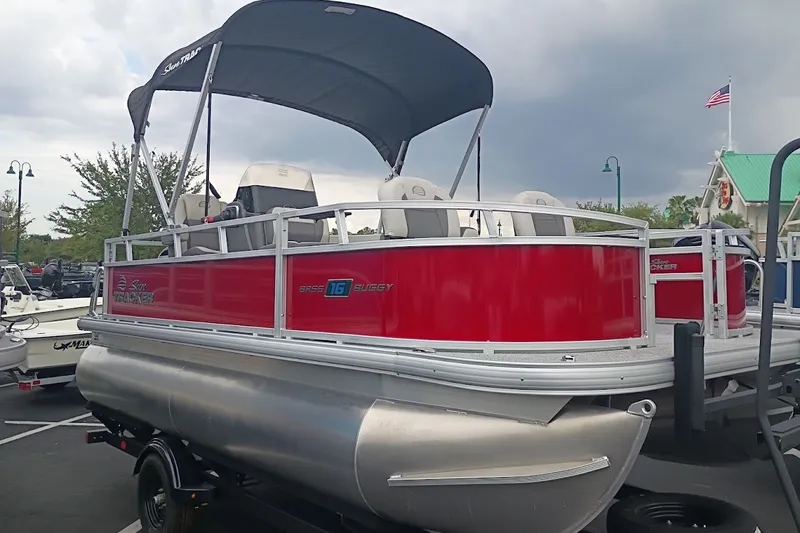 The Image of 2027 Sun Tracker Bass Buggy 16 XL Select pontoon boat with red exterior and canopy. - 0