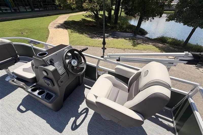 Slide: The Image of 2027 Sun Tracker Bass Buggy 16 XL Select pontoon boat interior with steering console and seating. - 18