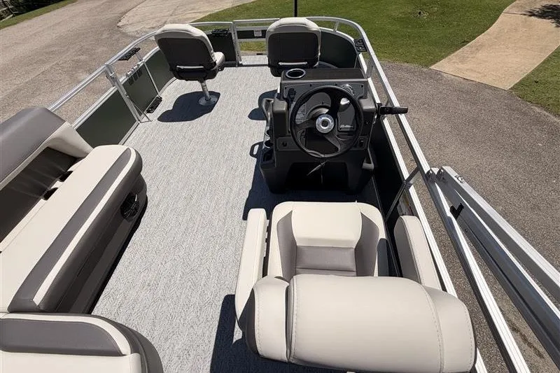 Slide: The Image of 2027 Sun Tracker Bass Buggy 16 XL Select pontoon boat interior with seating and steering console. - 17