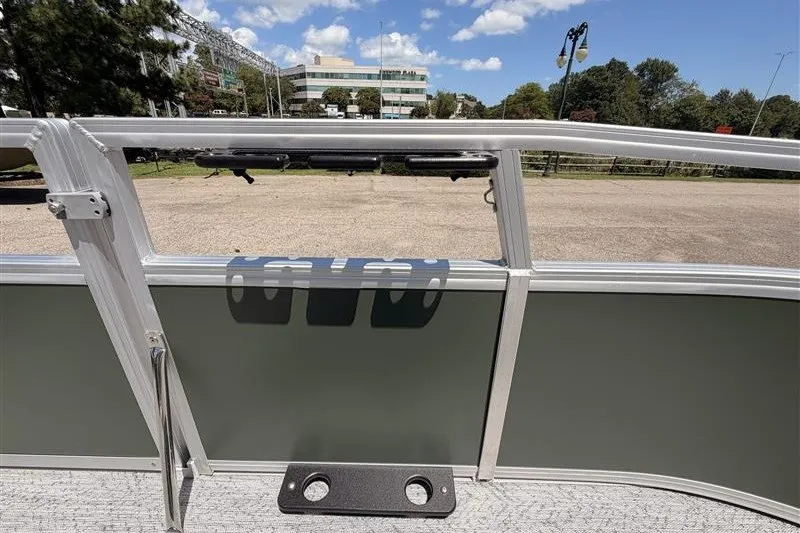 Slide: The Image of 2027 Sun Tracker Bass Buggy 16 XL Select pontoon boat interior with rod holders. - 15