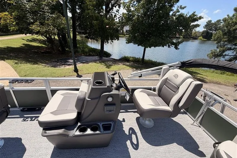 Slide: The Image of 2027 Sun Tracker Bass Buggy 16 XL Select pontoon boat interior with seating and steering console. - 19