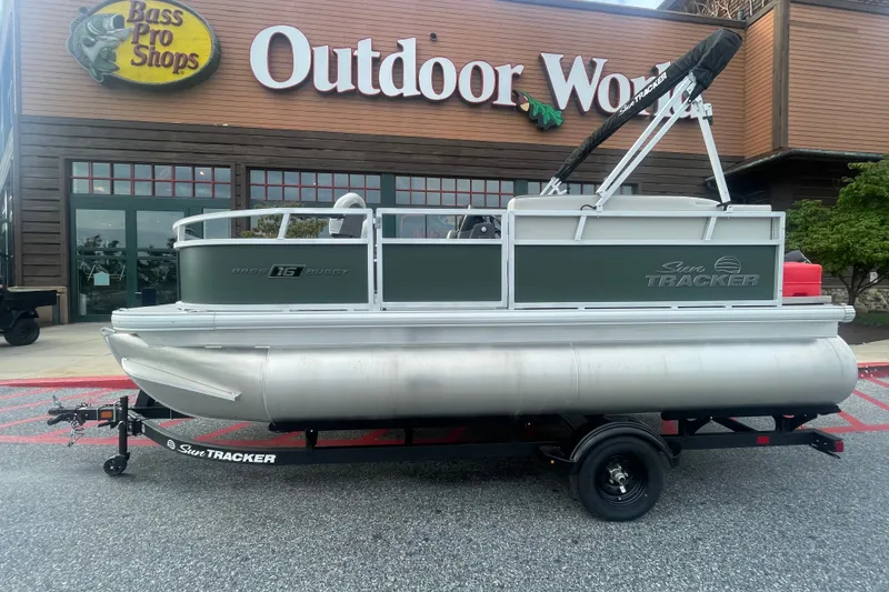 The Image of 2027 Sun Tracker Bass Buggy 16 XL Select pontoon boat outside Bass Pro Shops. - 0