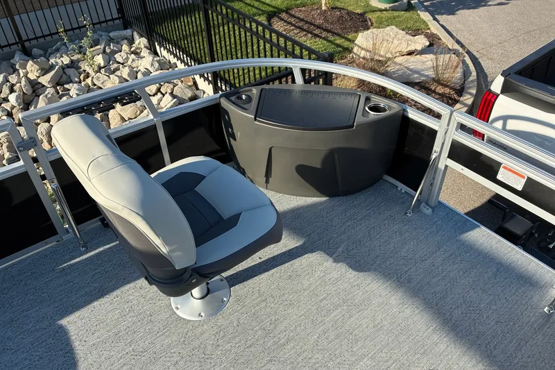 Slide: The Image of 2027 Sun Tracker Bass Buggy 18 DLX boat interior with seating and console. - 16