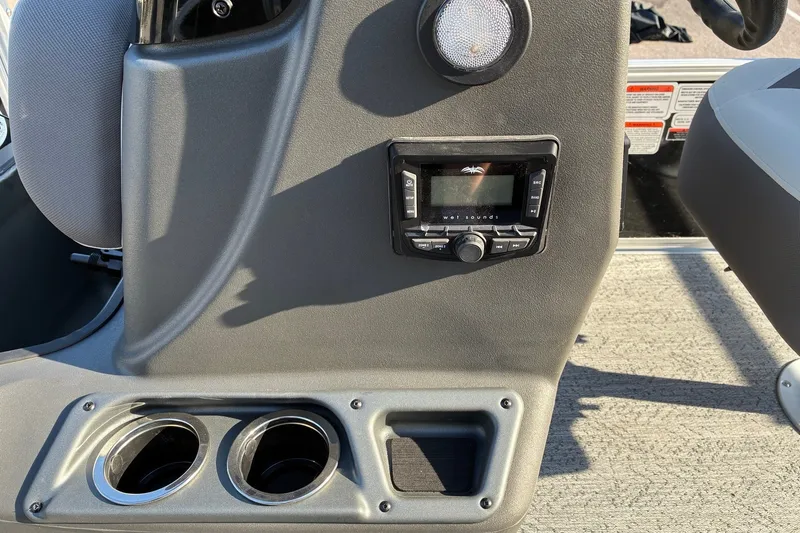 Slide: The Image of 2027 Sun Tracker Bass Buggy 18 DLX console with stereo system and cup holders. - 13