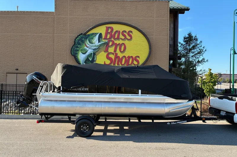 Slide: The Image of 2027 Sun Tracker Bass Buggy 18 DLX pontoon boat at Bass Pro Shops parking lot. - 17