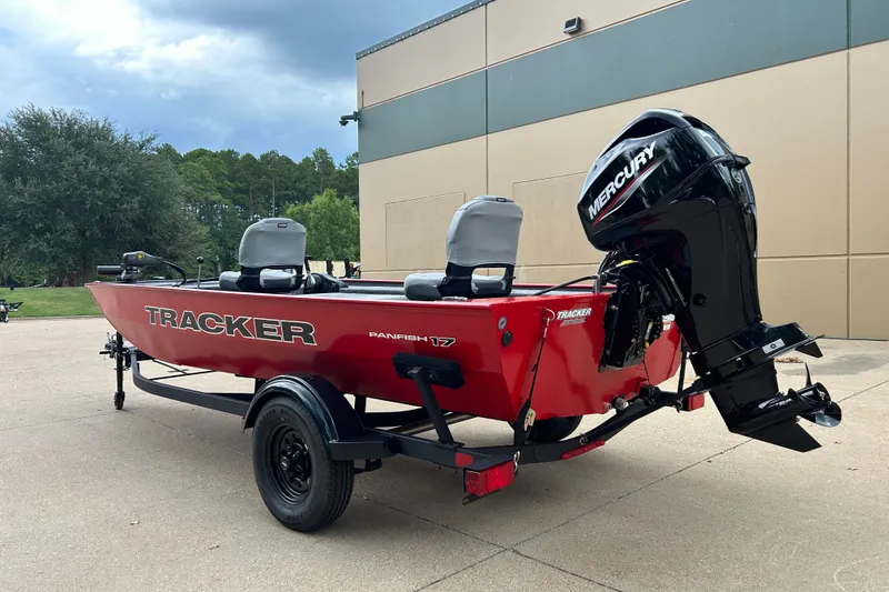 Slide: The Image of 2027 Tracker Panfish 17 boat with Mercury engine, parked outdoors. - 14