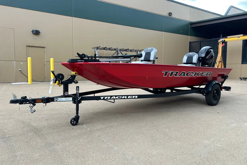 The Image of 2027 Tracker Panfish 17 boat in red on a trailer, parked outdoors. - 0