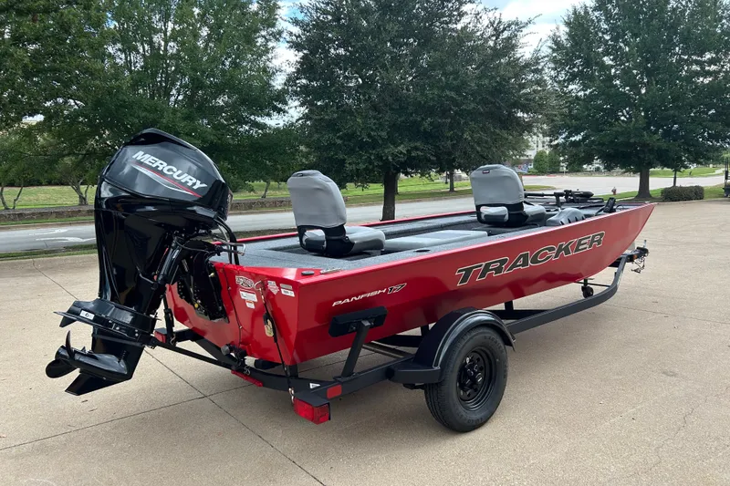 Slide: The Image of 2027 Tracker Panfish 17 boat with Mercury engine on trailer, parked outdoors. - 16