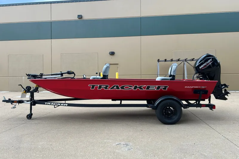 Slide: The Image of 2027 Tracker Panfish 17 boat in red, on a trailer, with Mercury outboard motor. - 13