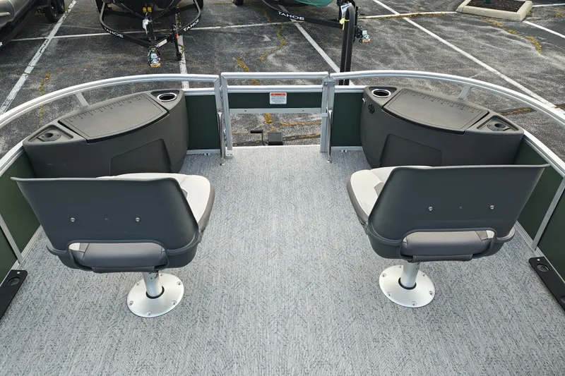 Slide: The Image of 2027 Sun Tracker Bass Buggy 18 DLX pontoon boat with dual swivel seats and storage compartments. - 33