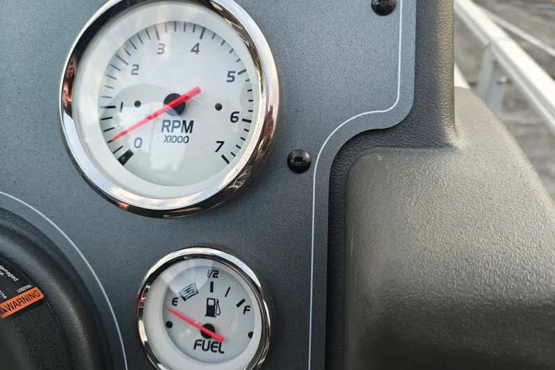 Slide: The Image of Close-up of RPM and fuel gauges on 2027 Sun Tracker Bass Buggy 18 DLX. - 23