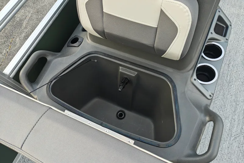 Slide: The Image of 2027 Sun Tracker Bass Buggy 18 DLX boat seat storage compartment with cup holders. - 31