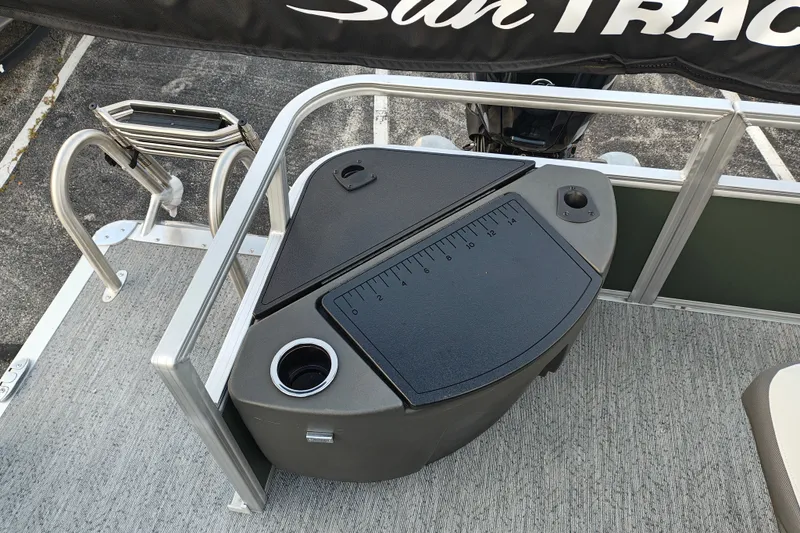 Slide: The Image of 2027 Sun Tracker Bass Buggy 18 DLX boat deck with fishing station and cup holder. - 18