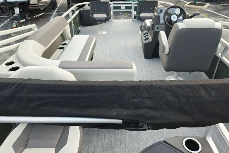 Slide: The Image of 2027 Sun Tracker Bass Buggy 18 DLX pontoon boat interior with seating and steering console. - 20