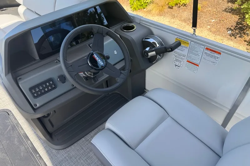Slide: The Image of 2027 Sun Tracker Party Barge 22 RF XP3 steering console with modern controls and comfortable seating. - 13
