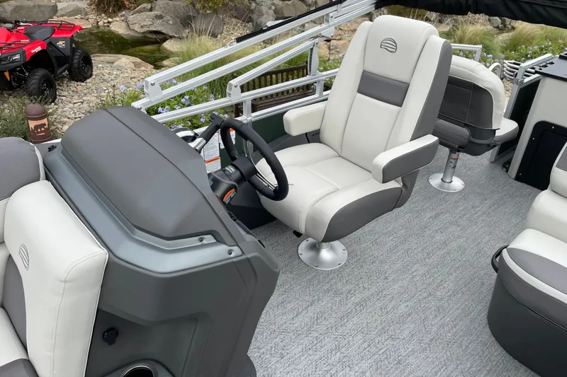 Slide: The Image of Interior of 2027 Sun Tracker Fishin' Barge 22 XP3 with plush seating and steering console. - 24