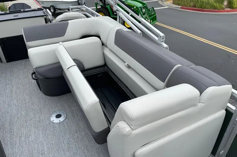 Slide: The Image of 2027 Sun Tracker Fishin' Barge 22 XP3 interior seating with storage compartment. - 19