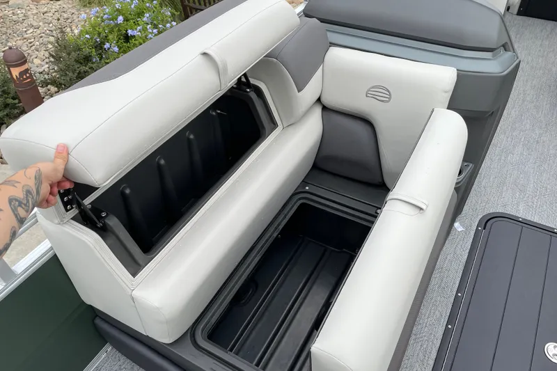 Slide: The Image of 2027 Sun Tracker Fishin' Barge 22 XP3 seat storage compartment open, revealing spacious interior. - 18
