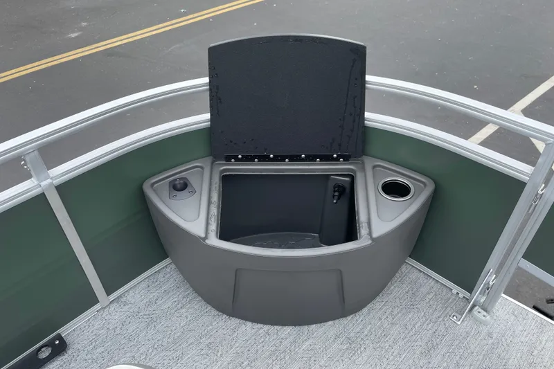 Slide: The Image of 2027 Sun Tracker Fishin' Barge 22 XP3 boat with open storage compartment and cup holder. - 16