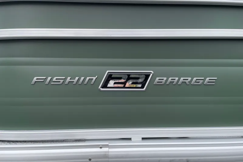 Slide: The Image of 2027 Sun Tracker Fishin' Barge 22 XP3 logo on green boat exterior. - 30