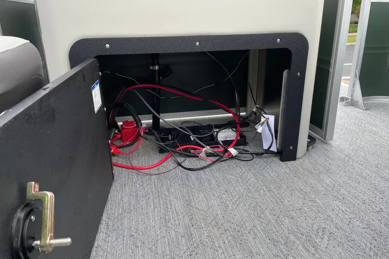 Slide: The Image of Open compartment of 2027 Sun Tracker Fishin' Barge 22 XP3 showing wiring and components. - 21