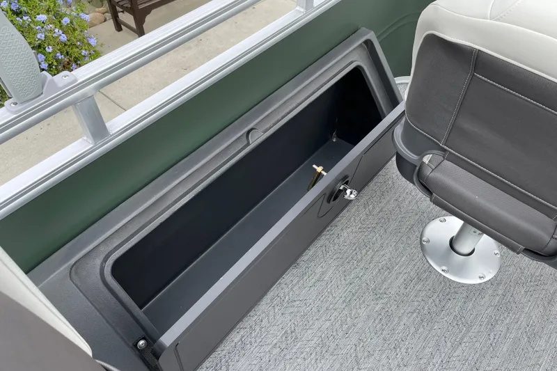 Slide: The Image of Interior view of 2027 Sun Tracker Fishin' Barge 22 XP3 with storage compartment and seat. - 23