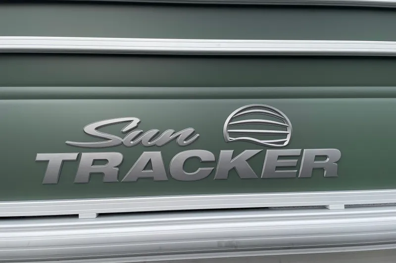 Slide: The Image of 2027 Sun Tracker Fishin' Barge 22 XP3 logo on green background. - 31