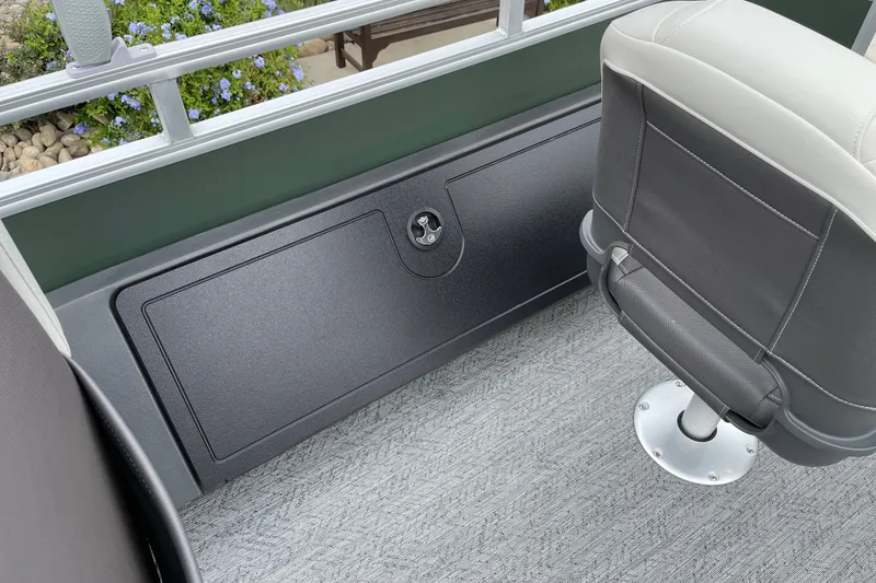 Slide: The Image of 2027 Sun Tracker Fishin' Barge 22 XP3 interior with seating and storage compartment. - 22