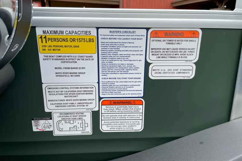 Slide: The Image of Safety and capacity labels on 2027 Sun Tracker Fishin' Barge 22 XP3 boat. - 29