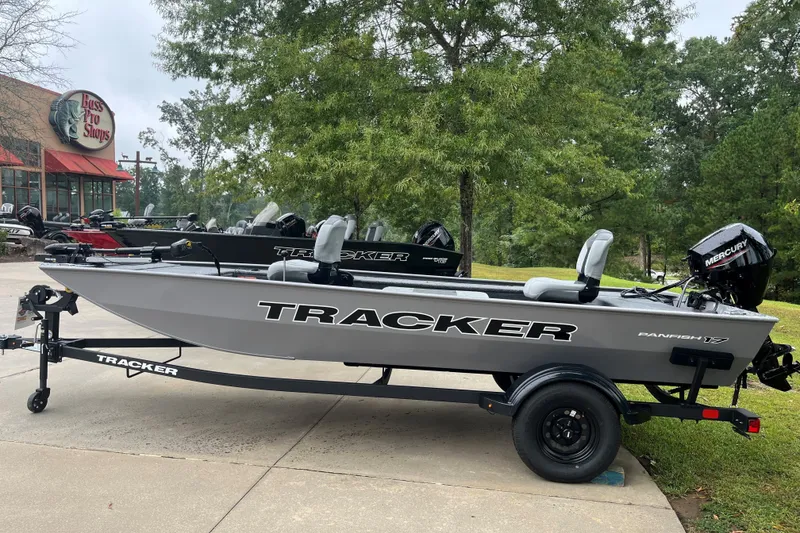The Image of 2027 Tracker Panfish 17 boat on trailer outside Bass Pro Shops. - 0