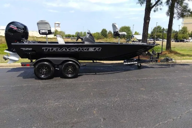 The Image of 2027 Tracker Savage 215 boat on trailer, parked outdoors, side view. - 0