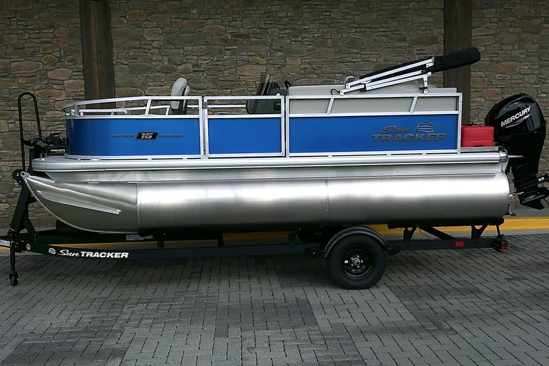 The Image of 2027 Sun Tracker Bass Buggy 16 XL Select pontoon boat on trailer, side view. - 0