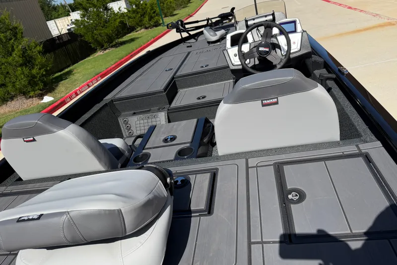 Slide: The Image of 2027 Tracker Savage 215 boat interior with gray seating and modern dashboard. - 16