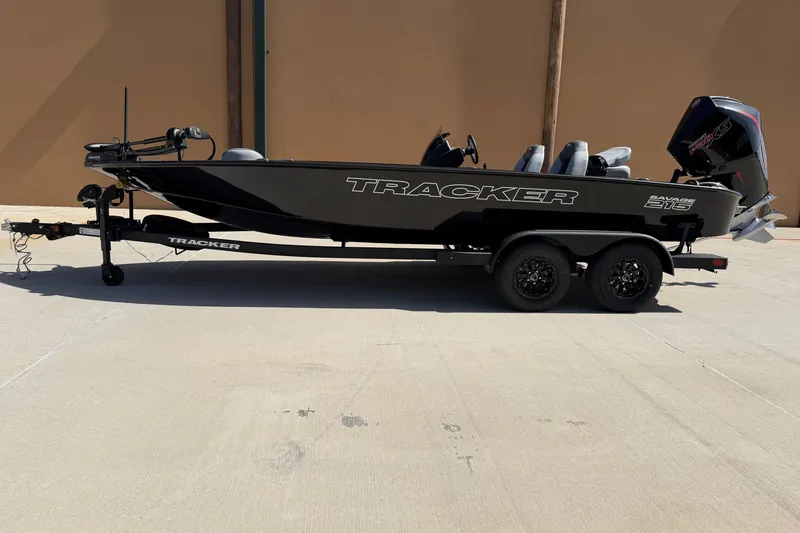 The Image of 2027 Tracker Savage 215 boat on trailer, side view in outdoor setting. - 0