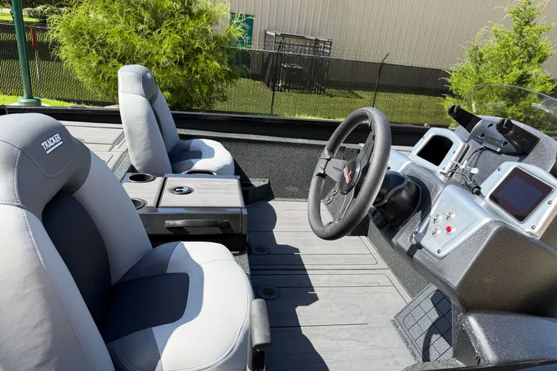 Slide: The Image of Interior of 2027 Tracker Savage 215 boat with steering wheel and seating. - 13