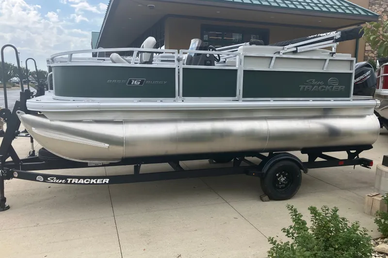 The Image of 2027 Sun Tracker Bass Buggy 16 XL Select pontoon boat on trailer, outdoor display. - 0