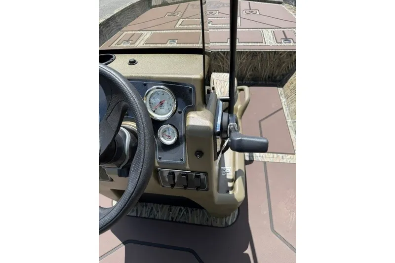 Slide: The Image of 2027 Tracker Grizzly 2072 CC boat console with steering wheel and gauges. - 18