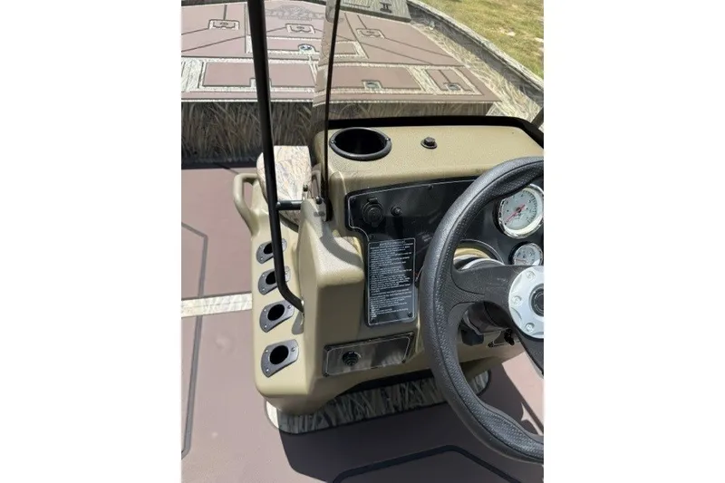 Slide: The Image of Center console of 2027 Tracker Grizzly 2072 CC boat with steering wheel and gauges. - 17