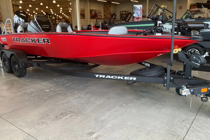 The Image of Red 2027 Tracker Savage 215 boat on trailer in showroom. - 0