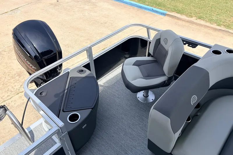 Slide: The Image of 2027 Sun Tracker Bass Buggy 18 DLX pontoon boat interior with seating and Mercury outboard motor. - 28