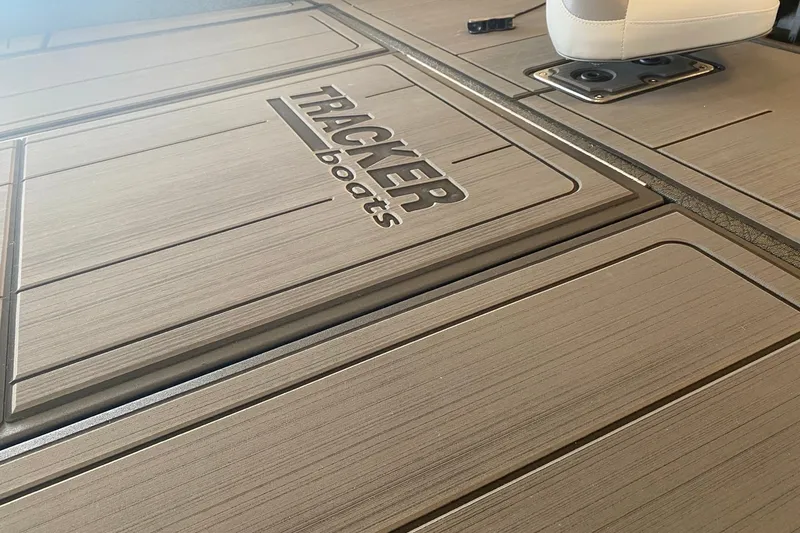 Slide: The Image of Tracker Savage 215 boat deck with logo, featuring sleek design and modern seating, 2027 model. - 53